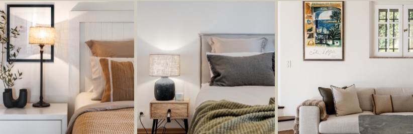 Bedside details with an olive branch and table lamp, a layered bed with a dark ceramic lamp, and a framed print above a cushioned sofa