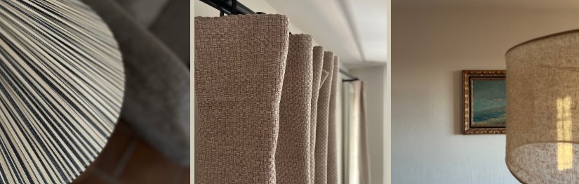 A pleated linen lampshade, floor-to-ceiling curtain folds, and a bedside lamp beside framed artwork