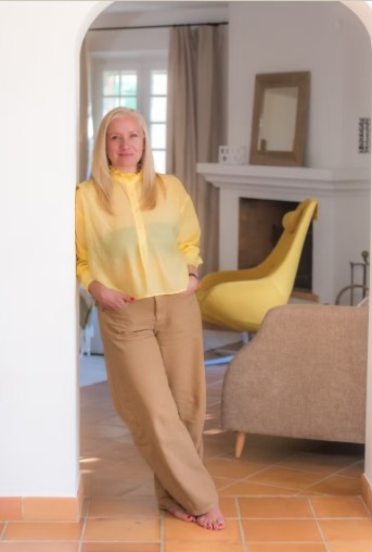 Jurgita Vainutyte, founder of SEIJAKU, standing in the archway of the Mediterranean holiday villa