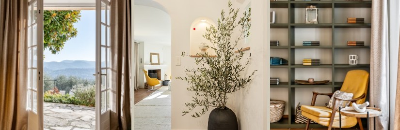 French doors opening to a hillside view, an olive branch in a black vase within an arched niche, and a styled bookshelf beside a yellow accent chair