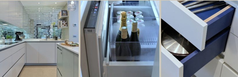 The mirrored splashback kitchen, a wine fridge drawer chilling champagne, and an open cutlery drawer