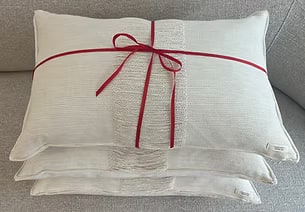 Two SEIJAKU cushions tied together with a red ribbon, ready to gift