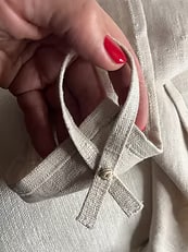 Close-up of a hand-stitched hanging loop on a SEIJAKU kitchen towel