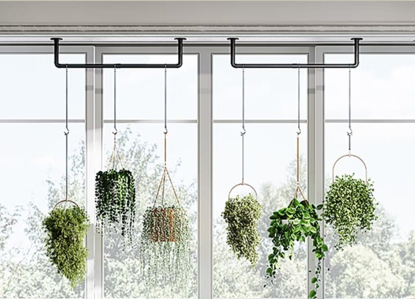 Hanging plants in woven holders in front of a bright window, styled for a wellness kitchen