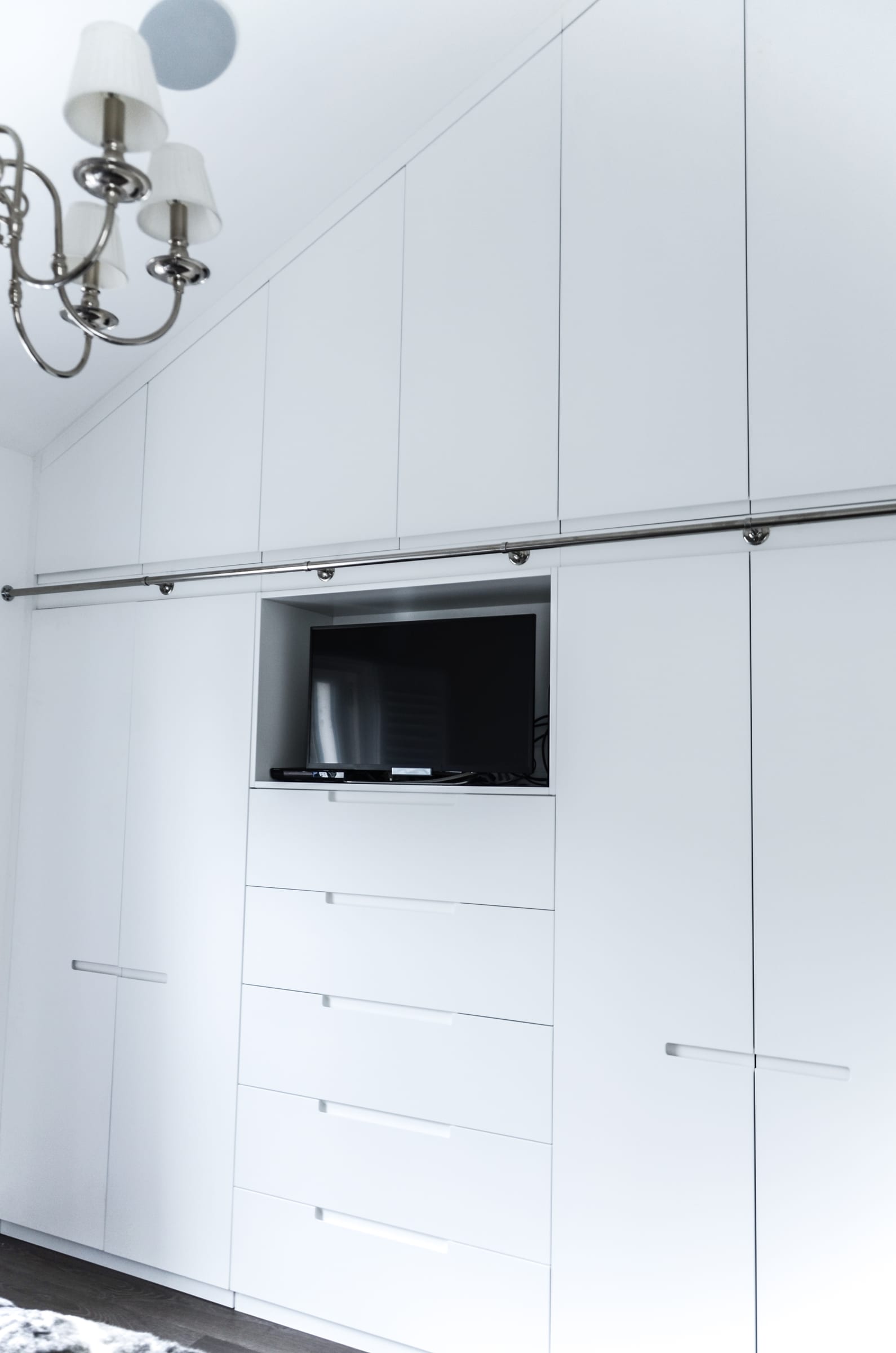 Kitchen counter detail with an extractor hood, framed print, and styled accessories in a Putney bespoke joinery project