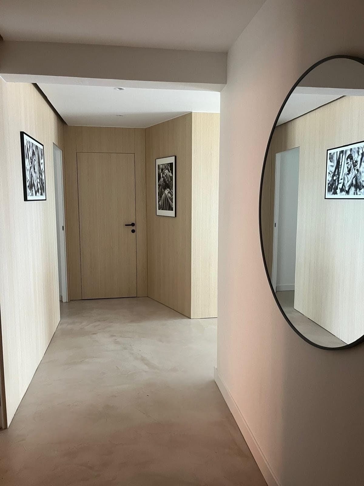 Contemporary living space at the Coastal Living apartment in Fabron with concrete floors and warm wood paneling